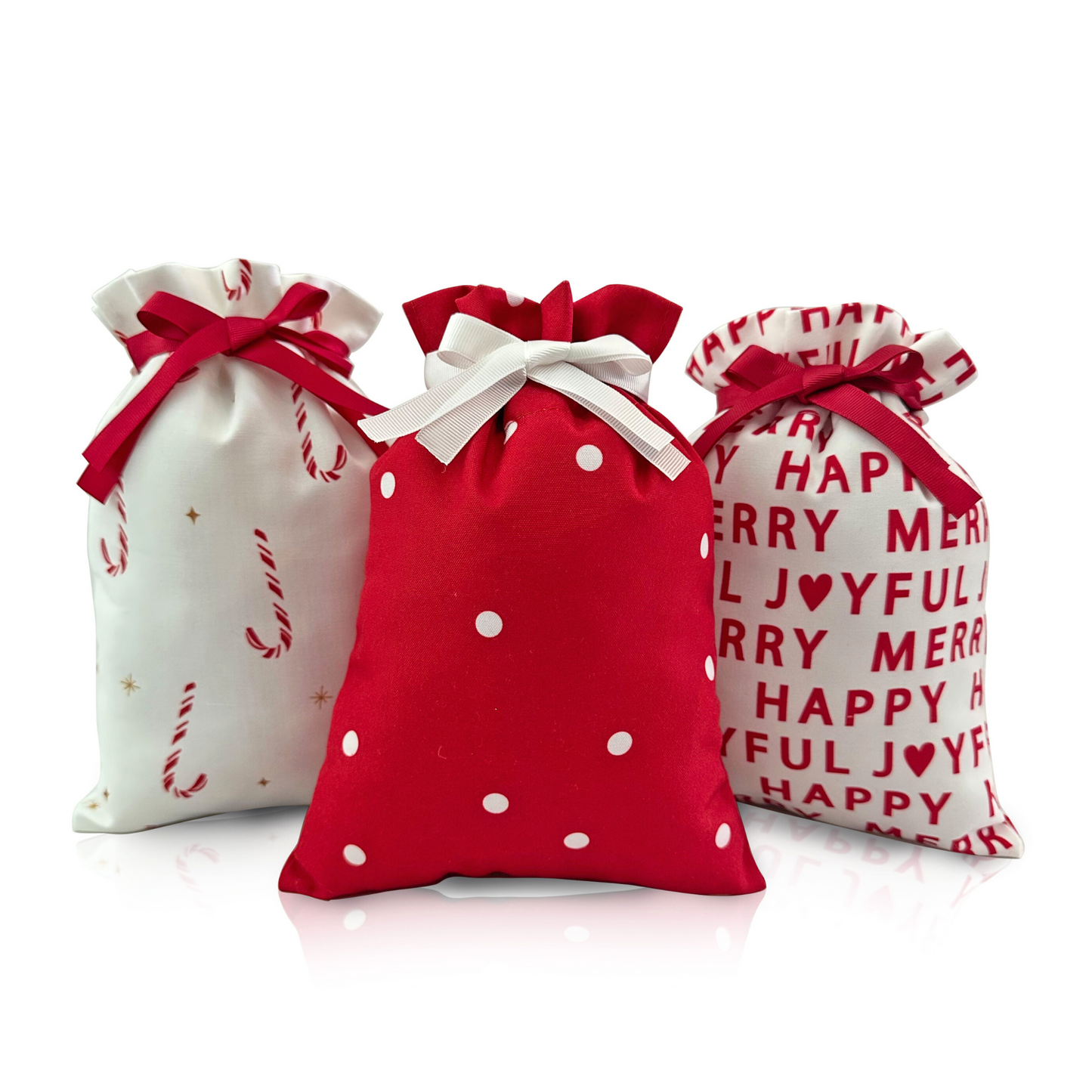 Three decorative gift bags with festive designs on a white background