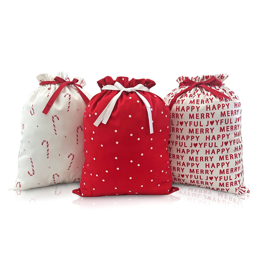 Three festive gift bags with different designs on a white background