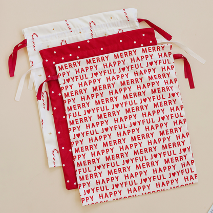 Red and white fabric with 'Merry Happy Joyful' text on a beige background