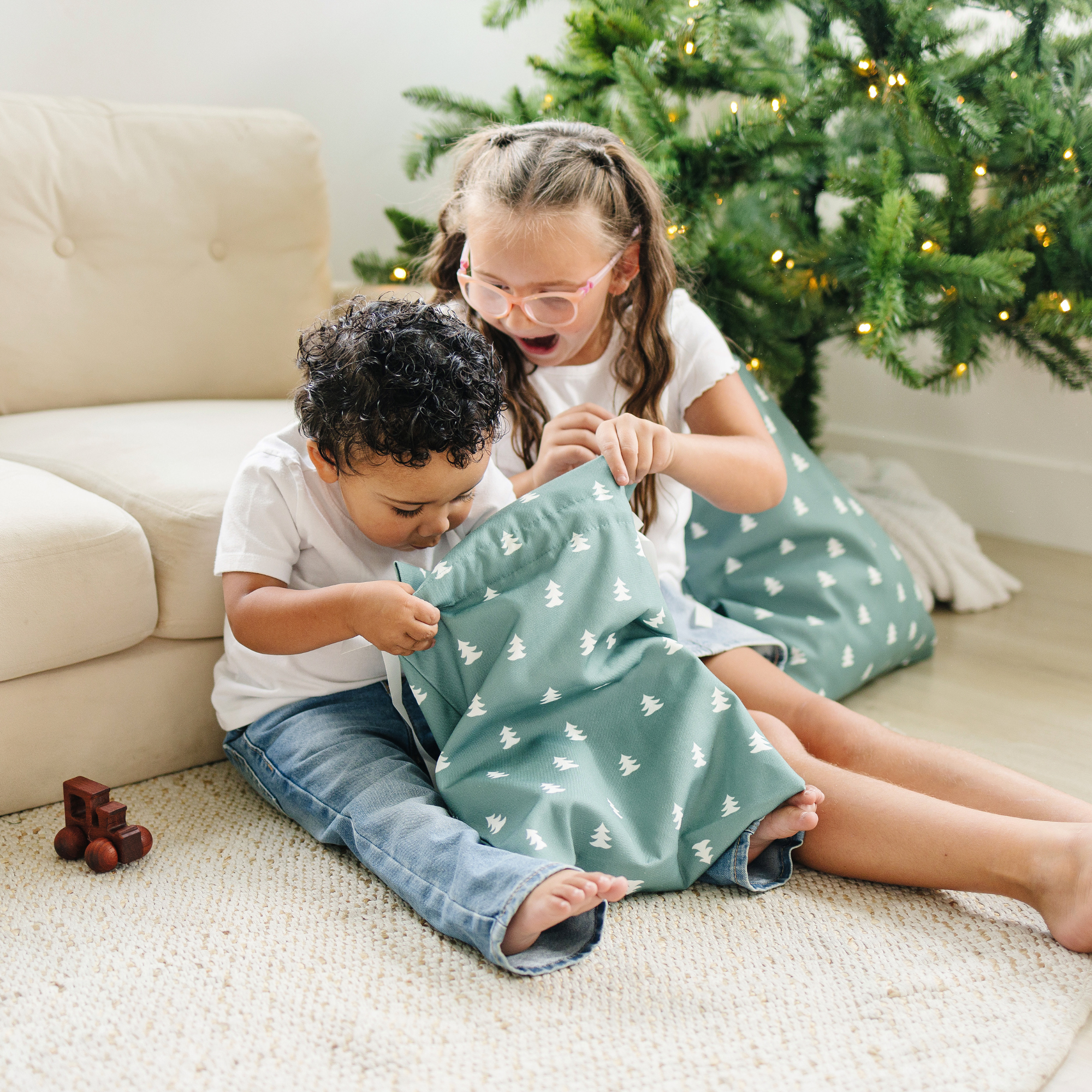 Drawstring fabric gift bag with tree pattern on a green background 