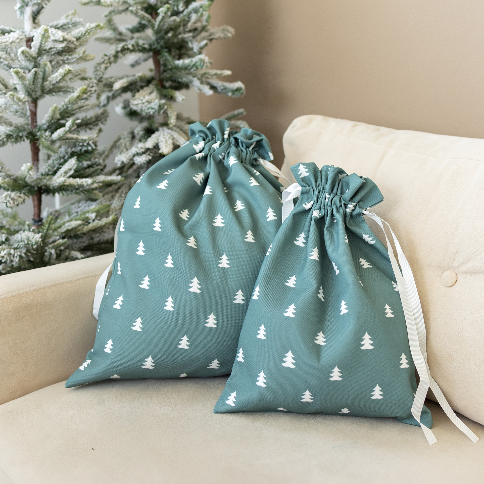 Drawstring fabric gift bag with tree pattern on a green background 