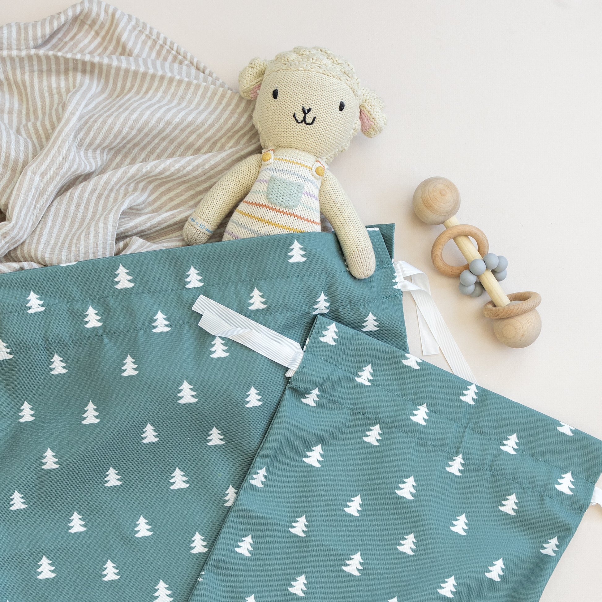 Drawstring fabric gift bag with tree pattern on a green background 