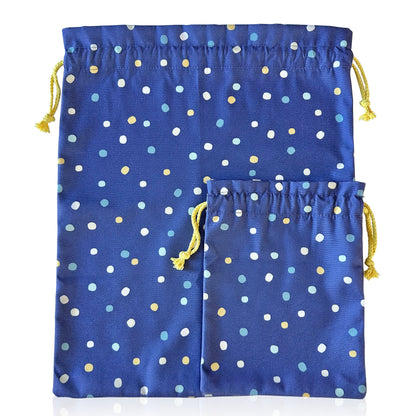 Two blue drawstring bags with colorful polka dots on a white background
